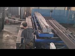 Workers and machines in the workshop are producing wire mesh.